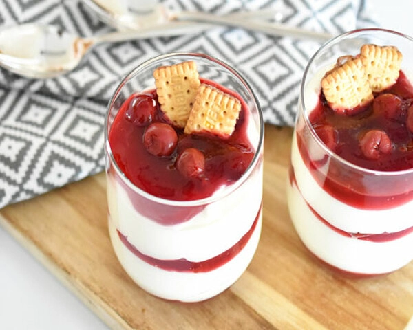 mousse blanca con cerezas ácidas en un vaso